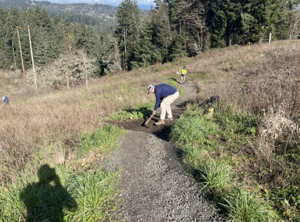 Jim working on a rolling drain dip with Marlon using a weed-eater.
