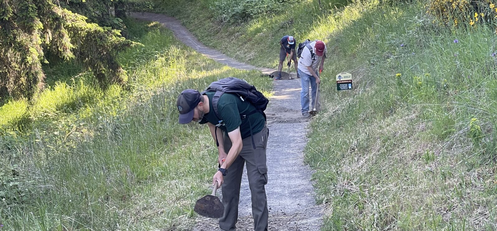 Joe, Dan, and Beejay chipping in drainage through the trail tread.