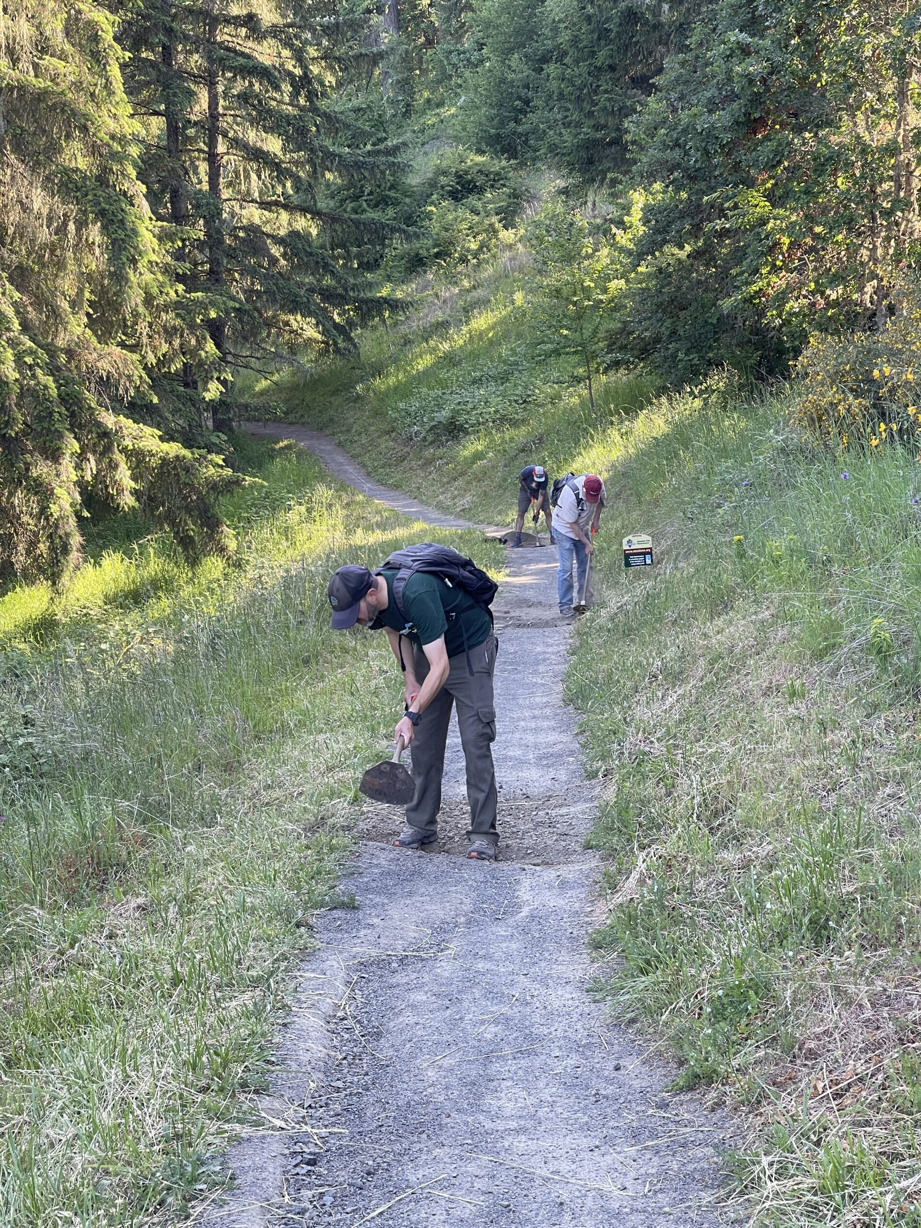 Joe, Dan, and Beejay chipping in drainage through the trail tread.