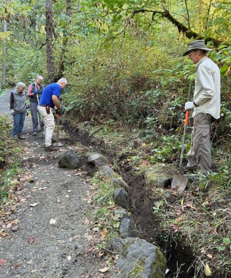 Jim, Denise, Lisa, and Jonathan working to clear and armor the drainage ditch.