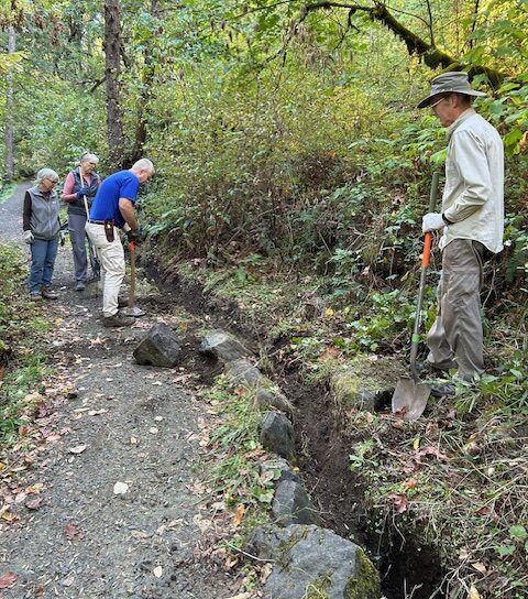Jim, Denise, Lisa, and Jonathan working to clear and armor the drainage ditch.