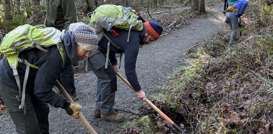 Barb and Matt remove debris from a drainage ditch.