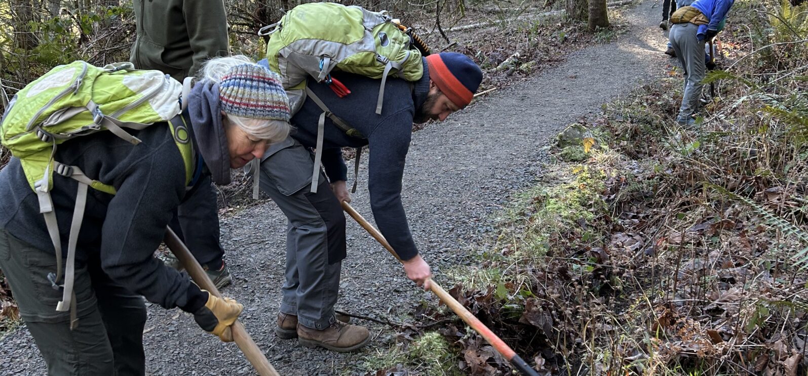 Barb and Matt remove debris from a drainage ditch.
