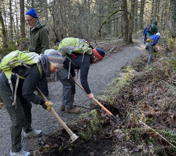 Barb and Matt remove debris from a drainage ditch.