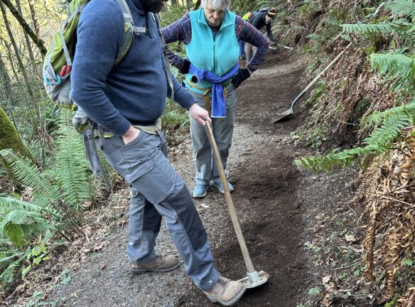 Matt explains the details of using the Terra hoe to shave off small amounts of material to sculpt the tread to Betty.