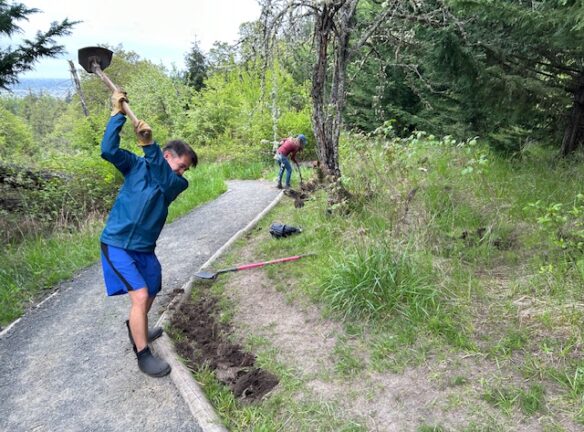 Sony swinging a Terra hoe and Teresa digging.