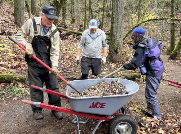 Michael and Jennifer shoveling mulch.