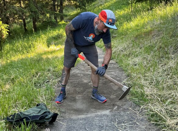 Beejay sculpting drainage through the trail tread.