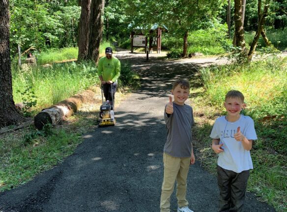 Matt compacting while Naith and Fletcher give their approval.